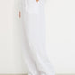 Coastline Pants in ivory linen shown in movement, relaxed straight-leg summer pants made in Canada