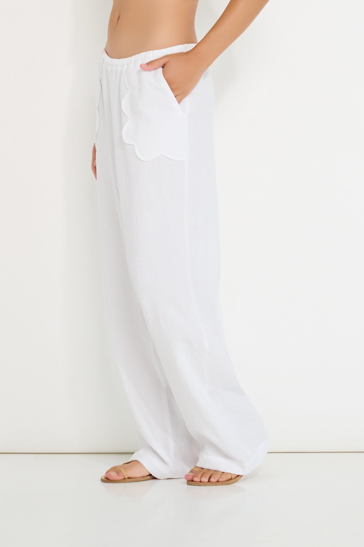 Coastline Pants in ivory linen shown in movement, relaxed straight-leg summer pants made in Canada