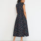 Reverie midi dress back view in black Petit Surfer French cotton seersucker with drop waist silhouette and spaghetti belt made in Canada