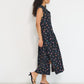 Reverie midi dress side view in black Petit Surfer French cotton seersucker with drop waist silhouette and side slits made in Canada