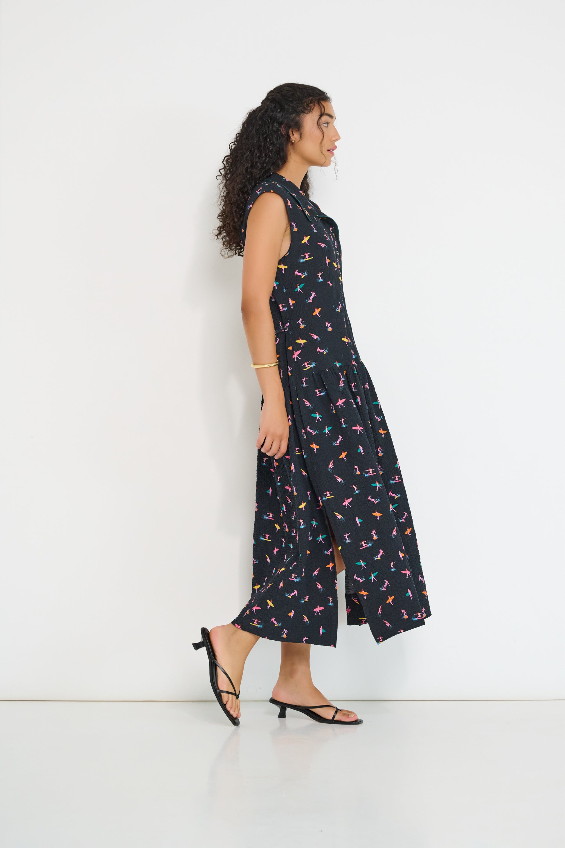 Reverie midi dress side view in black Petit Surfer French cotton seersucker with drop waist silhouette and side slits made in Canada