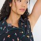 Model wearing Reverie Vest Petit Surfer asymmetrical embroidered button-tab closure with seashell buttons made in Canada