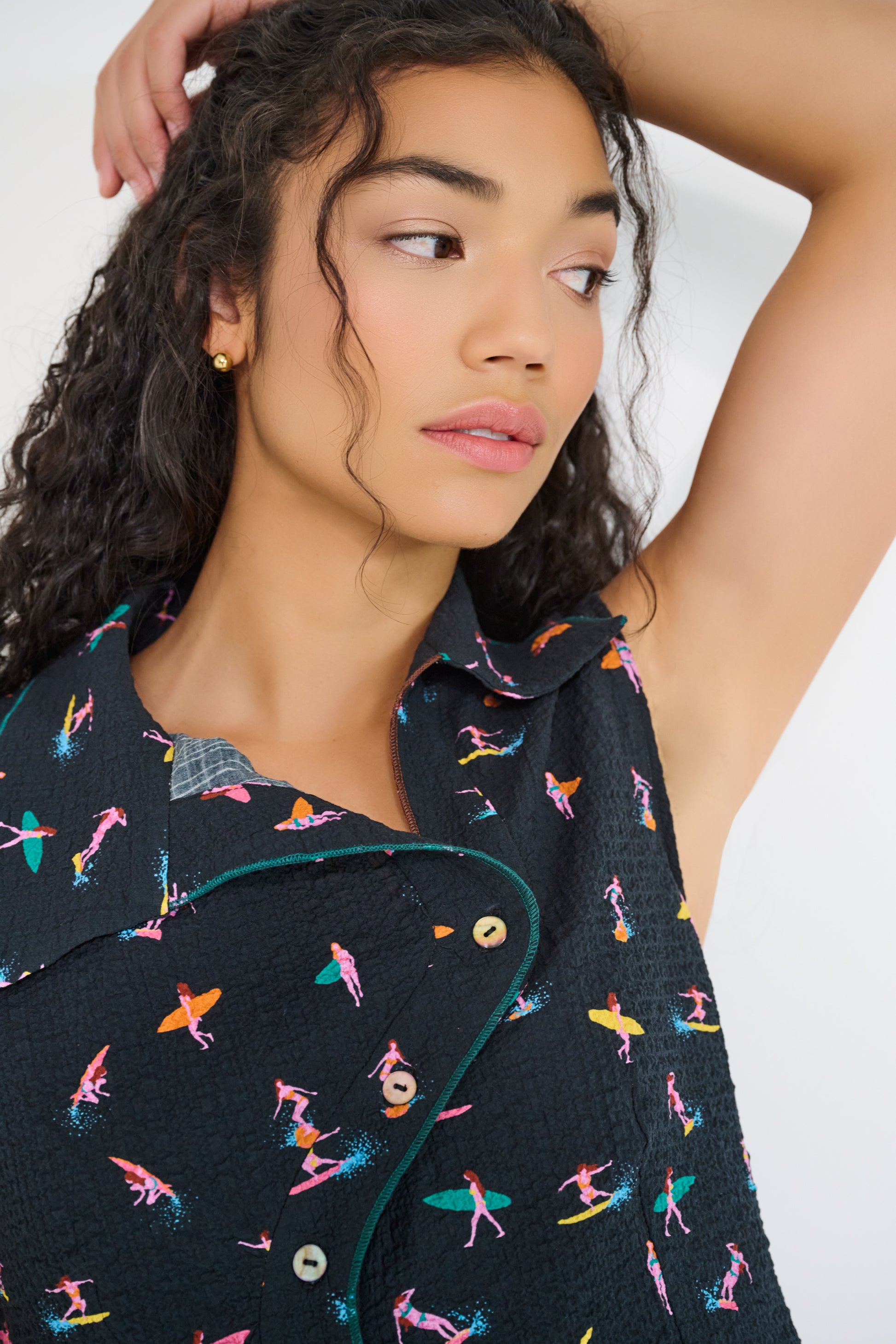 Model wearing Reverie Vest Petit Surfer asymmetrical embroidered button-tab closure with seashell buttons made in Canada