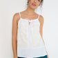 Stellaire Camisole in white linen with ivory lace detail and front tie neckline, made in Canada