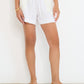 Stellaire Shorts in white linen with ivory lace patch pockets and elastic waist, made in Montreal