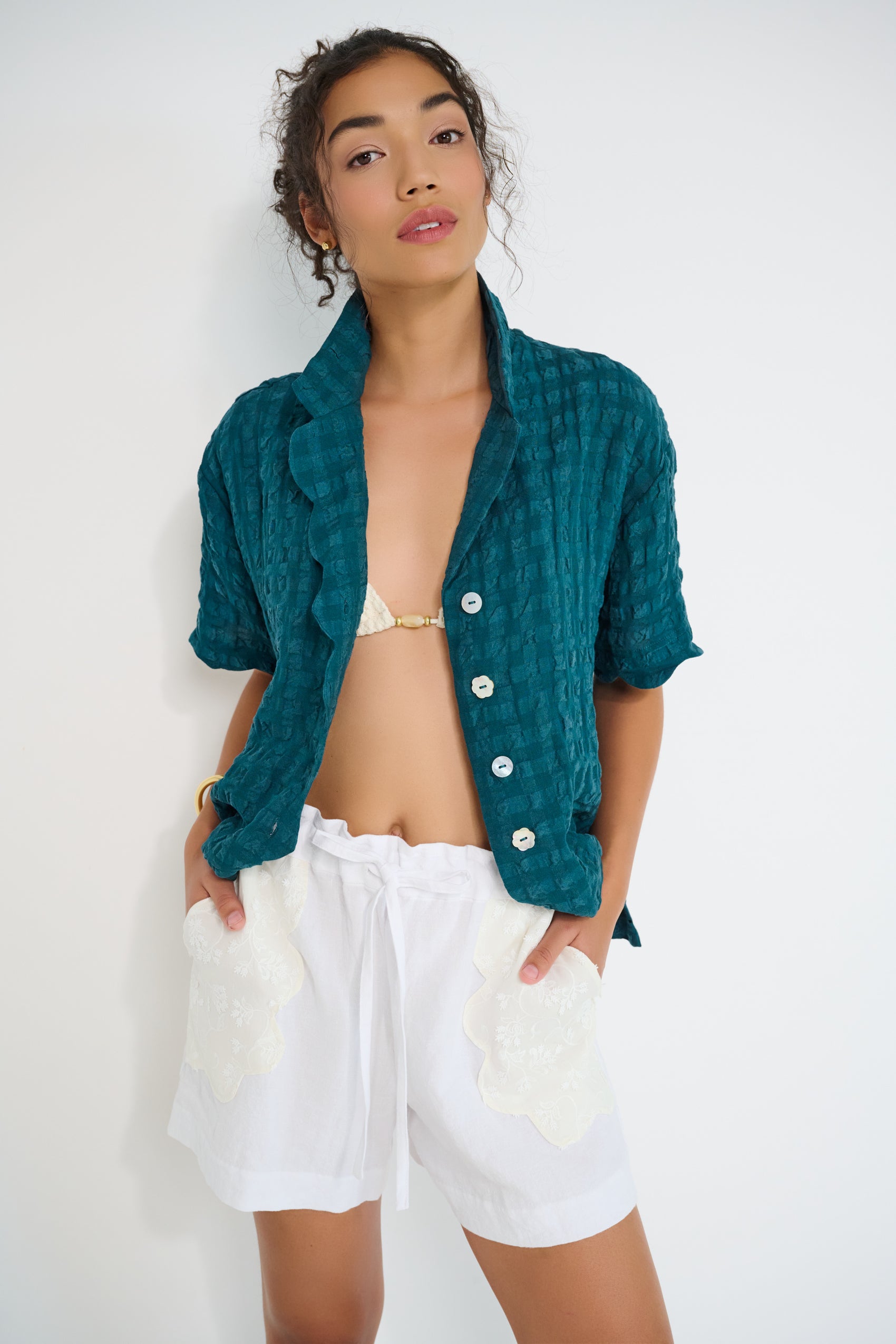 Stellaire Shorts in white linen with ivory lace patch pockets styled for summer, made in Montreal