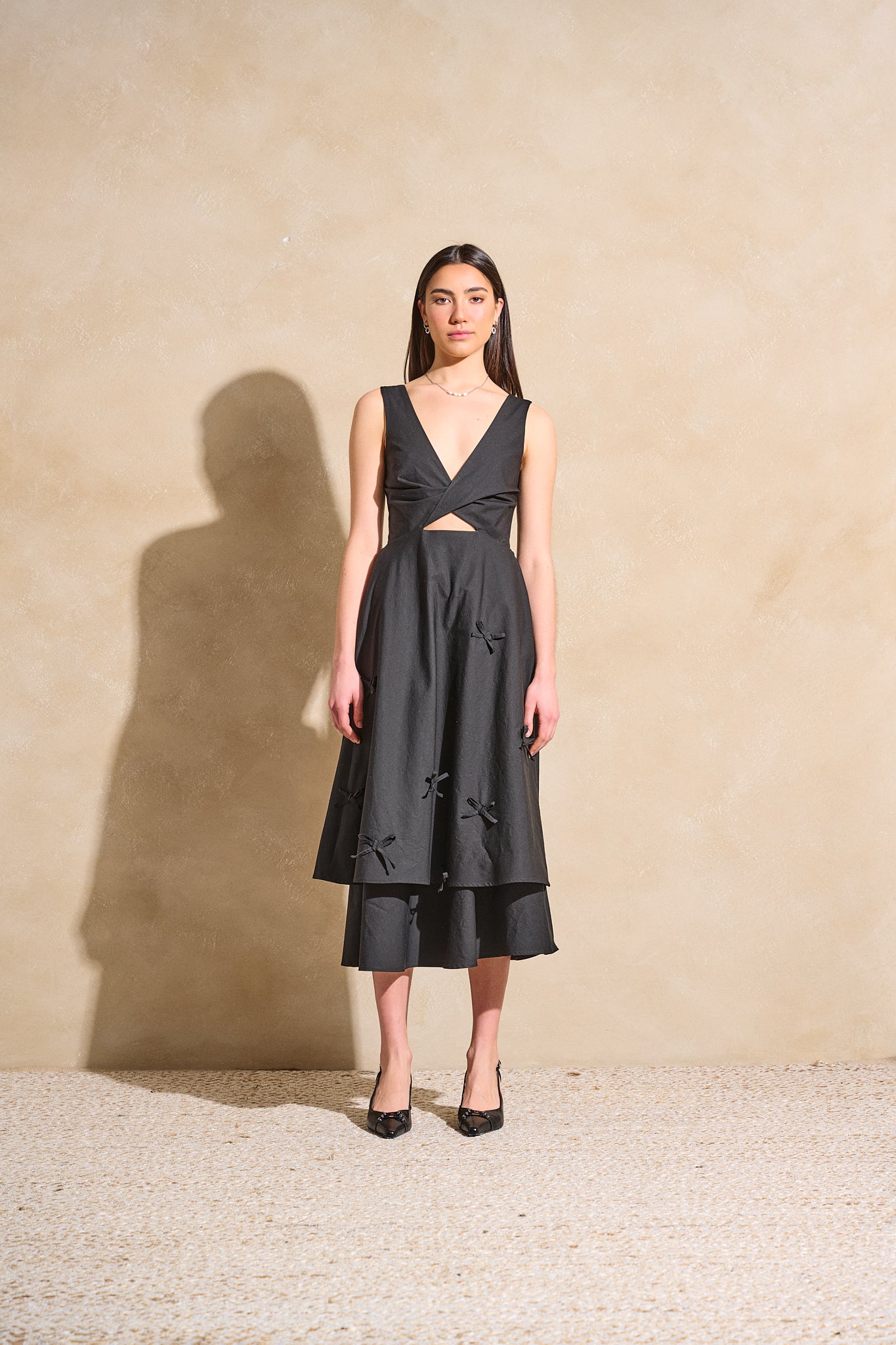 Twisted Basics dress in black Japanese twill with bow appliqué skirt and flattering twisted bodice – Made in Canada