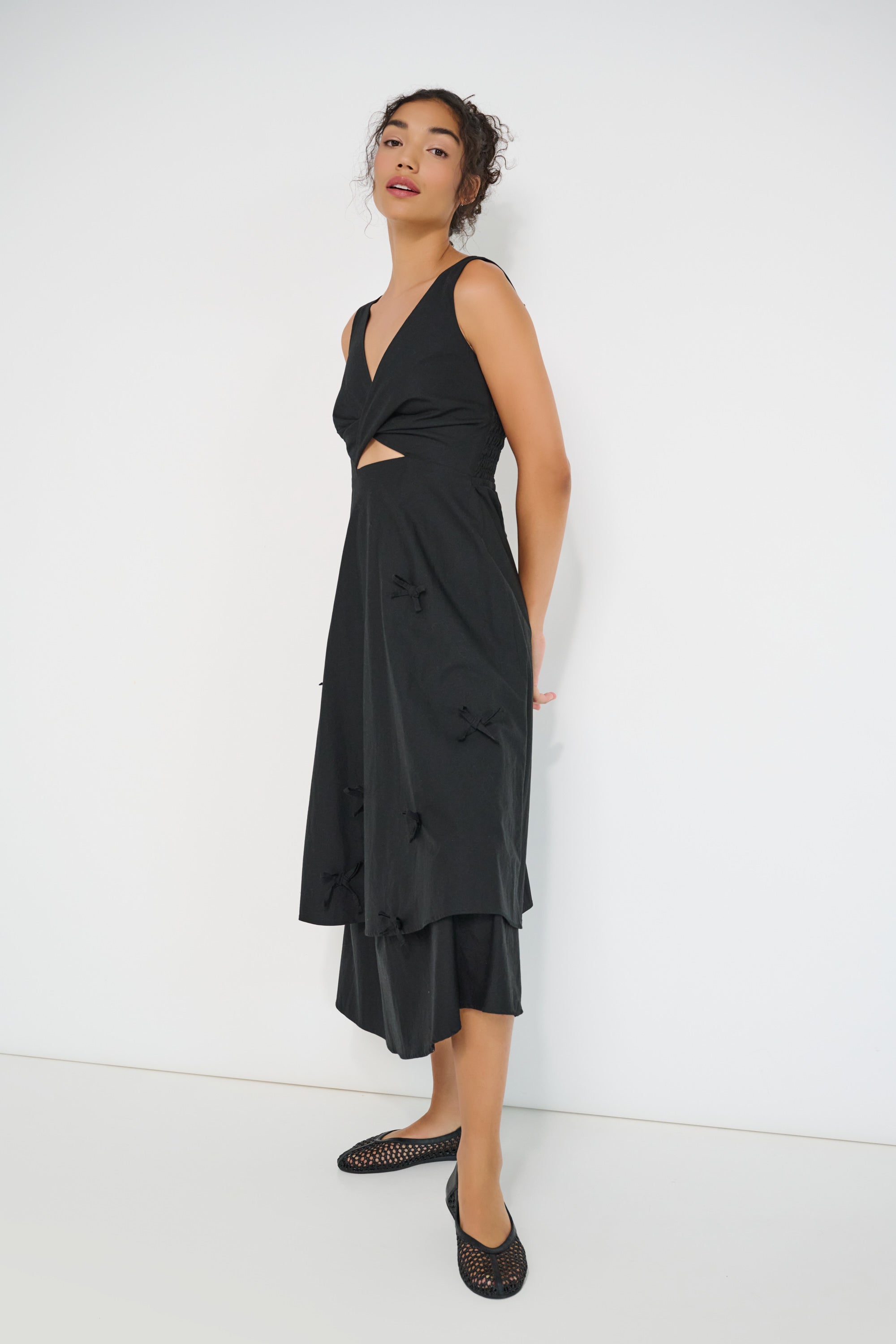 Twisted Basics dress in black Japanese twill side view showing layered skirt and twisted front detail – Made in Canada