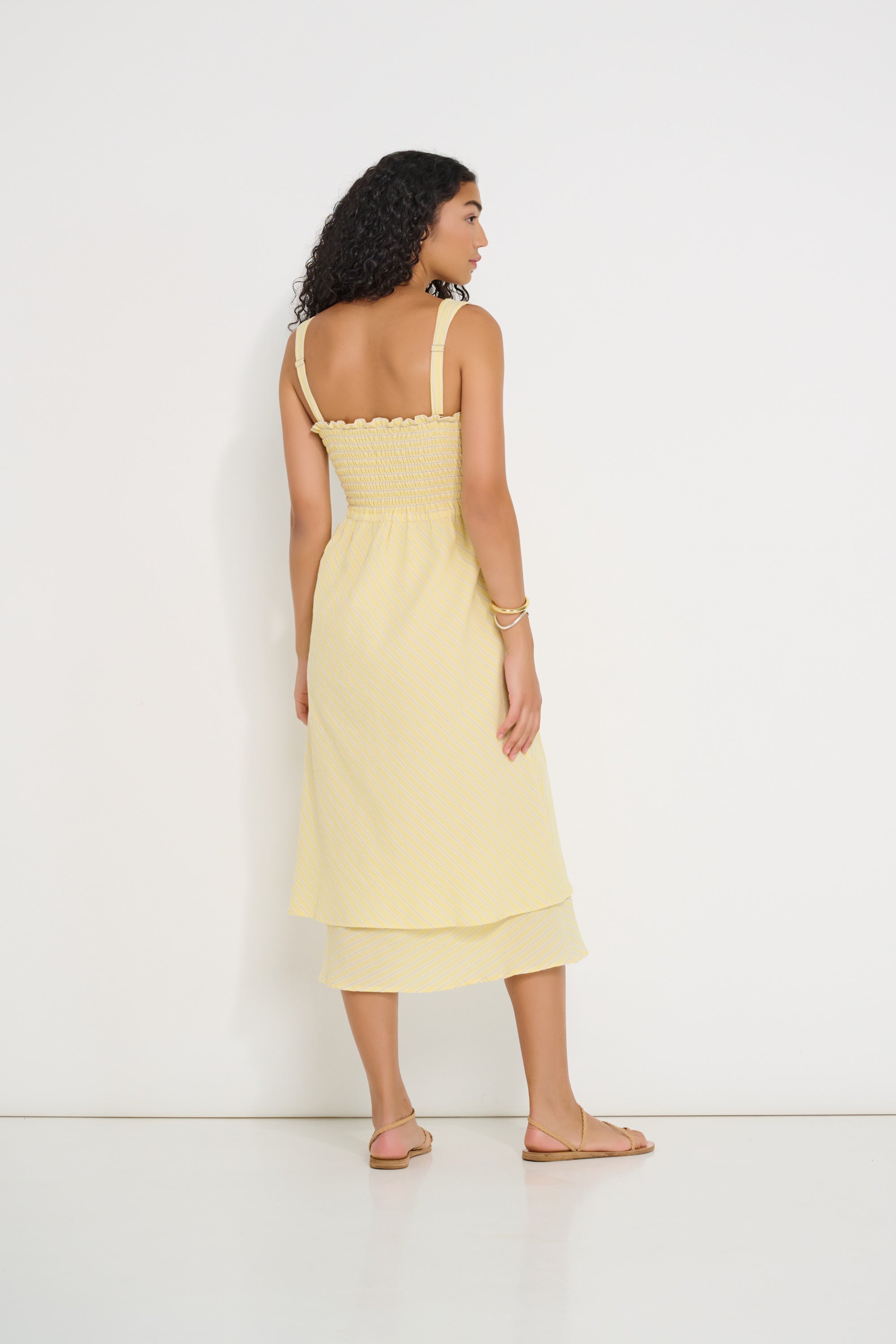 Ultimate Summer Dress in butter yellow striped Japanese cotton, back view showing shirred bodice and midi-length skirt, made in Canada