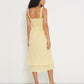 Ultimate Summer Dress in butter yellow striped Japanese cotton, back view showing shirred bodice and midi-length skirt, made in Canada