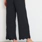 Voyage Pants black linen-viscose seersucker straight-leg pants back view with elastic waistband and scalloped hem, made in Canada.