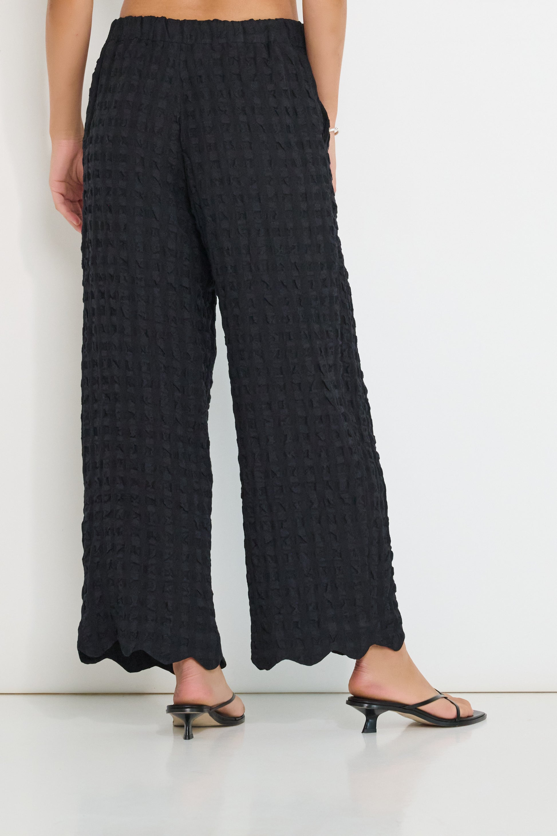 Voyage Pants black linen-viscose seersucker straight-leg pants back view with elastic waistband and scalloped hem, made in Canada.