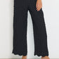 Voyage Pants black linen-viscose seersucker straight-leg pants front detail showing elastic waistband and textured fabric, made in Canada.
