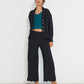 Voyage Pants black linen-viscose seersucker straight-leg pants with scalloped hem styled with Voyage Jacket matching set, made in Canada.