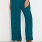 Deep teal Voyage Pants in linen-viscose seersucker with elastic waistband and scalloped hem, made in Canada