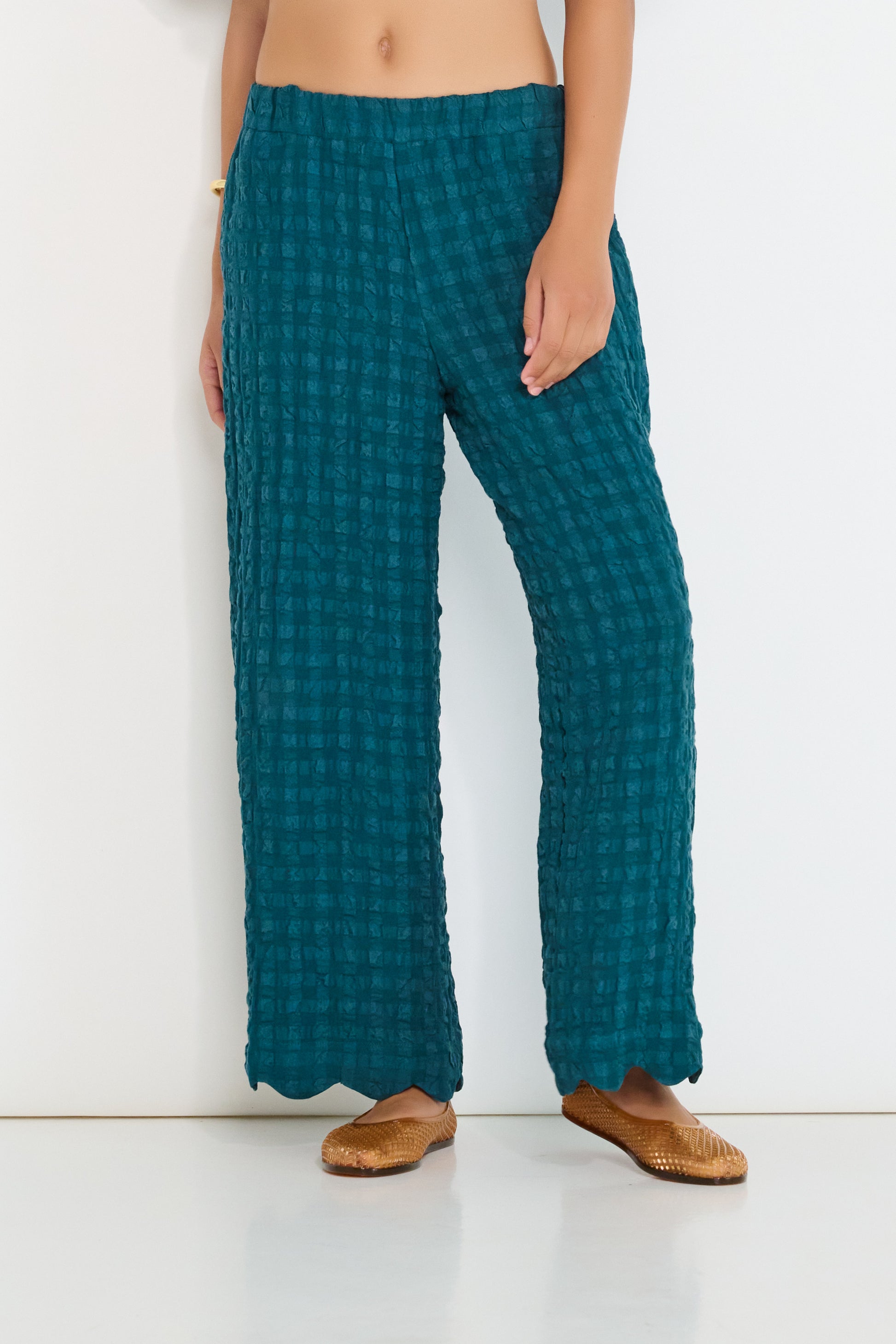 Deep teal Voyage Pants in linen-viscose seersucker with elastic waistband and scalloped hem, made in Canada