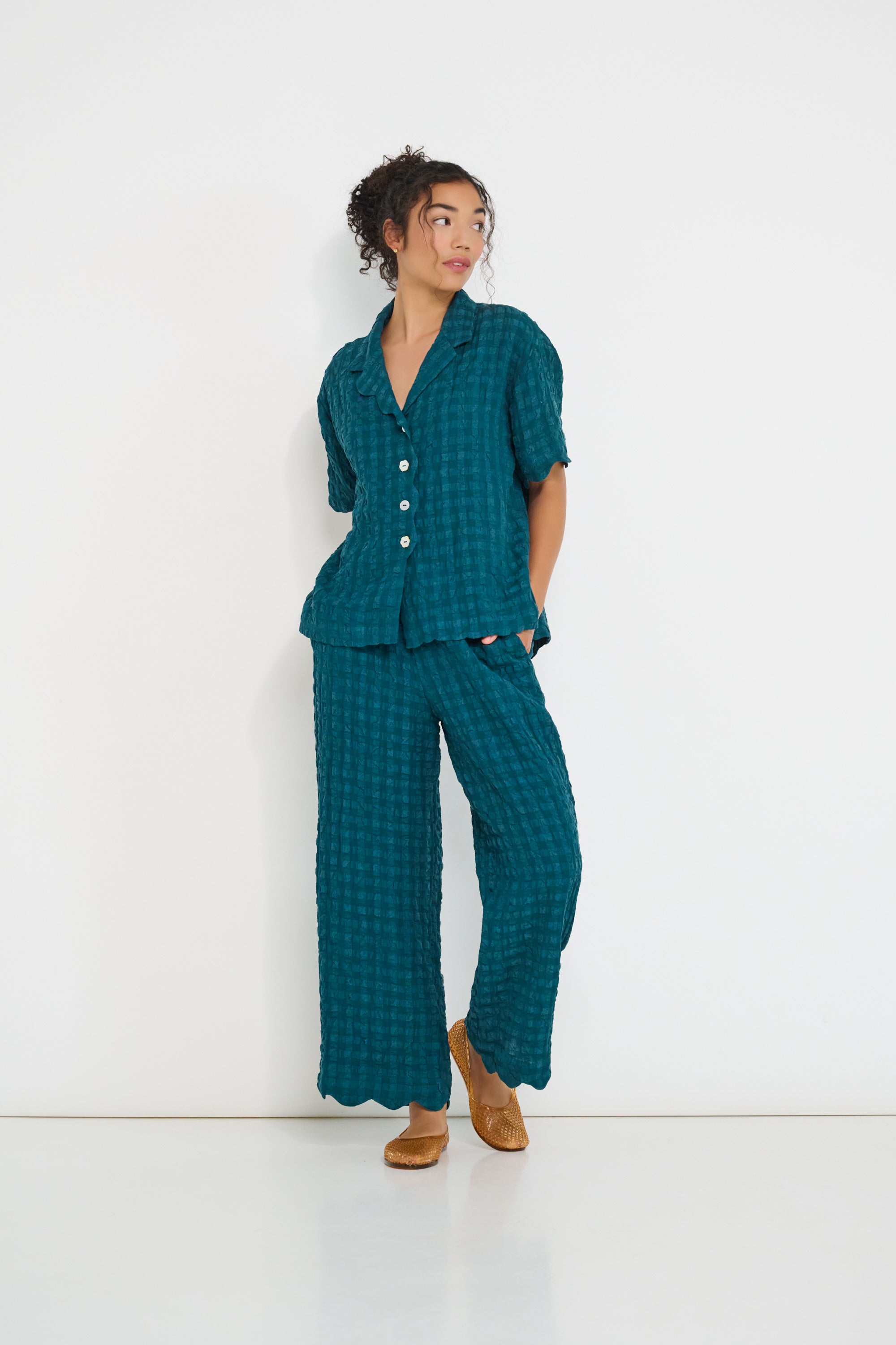 Voyage Shirt deep teal seersucker worn with Voyage Pants – relaxed summer set made in Canada with scalloped edges
