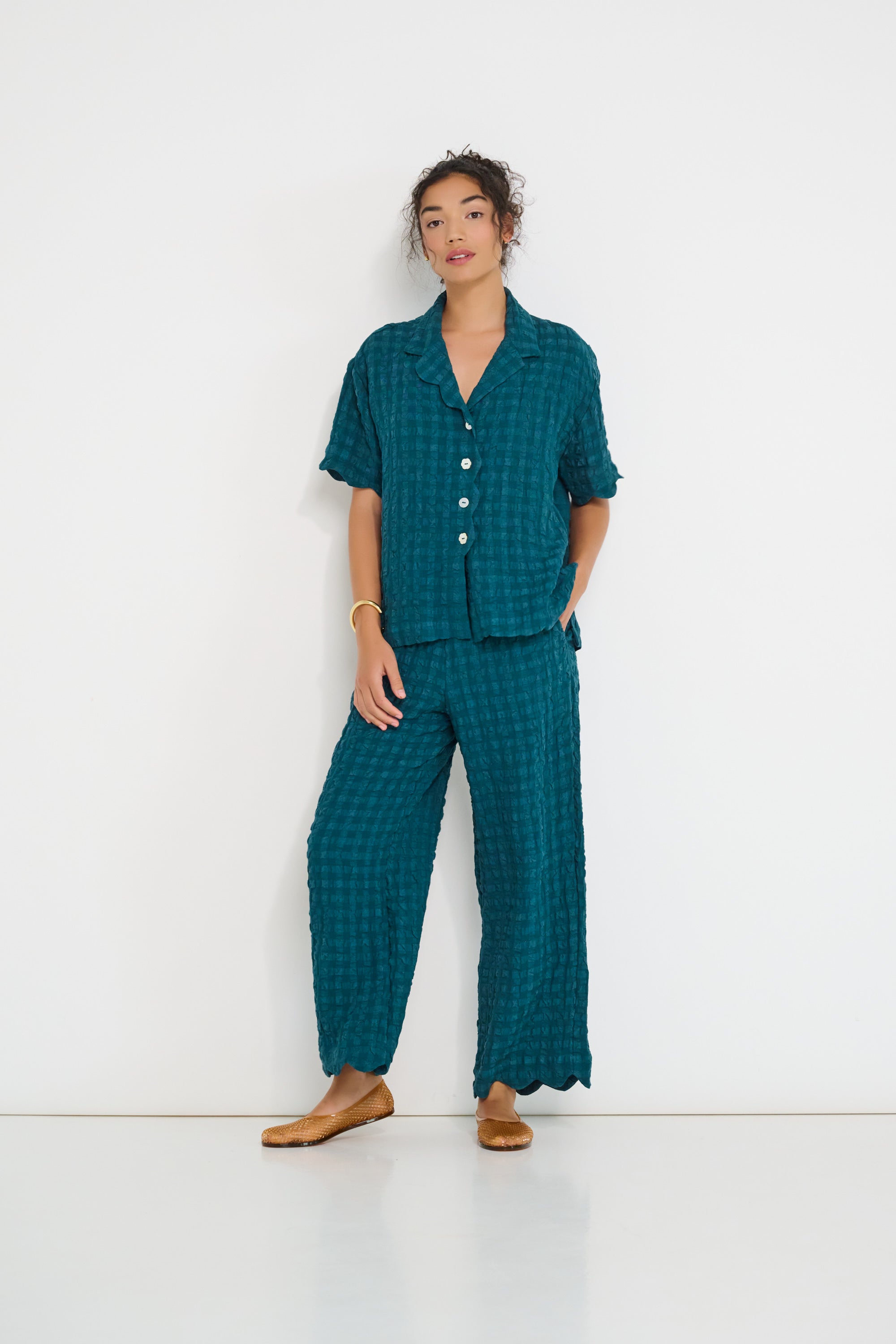 Voyage Shirt deep teal seersucker worn with Voyage Pants – relaxed summer set made in Canada with scalloped edges