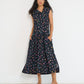 Reverie midi dress front view in black Petit Surfer French cotton seersucker with embroidered asymmetrical closure and drop waist silhouette made in Canada