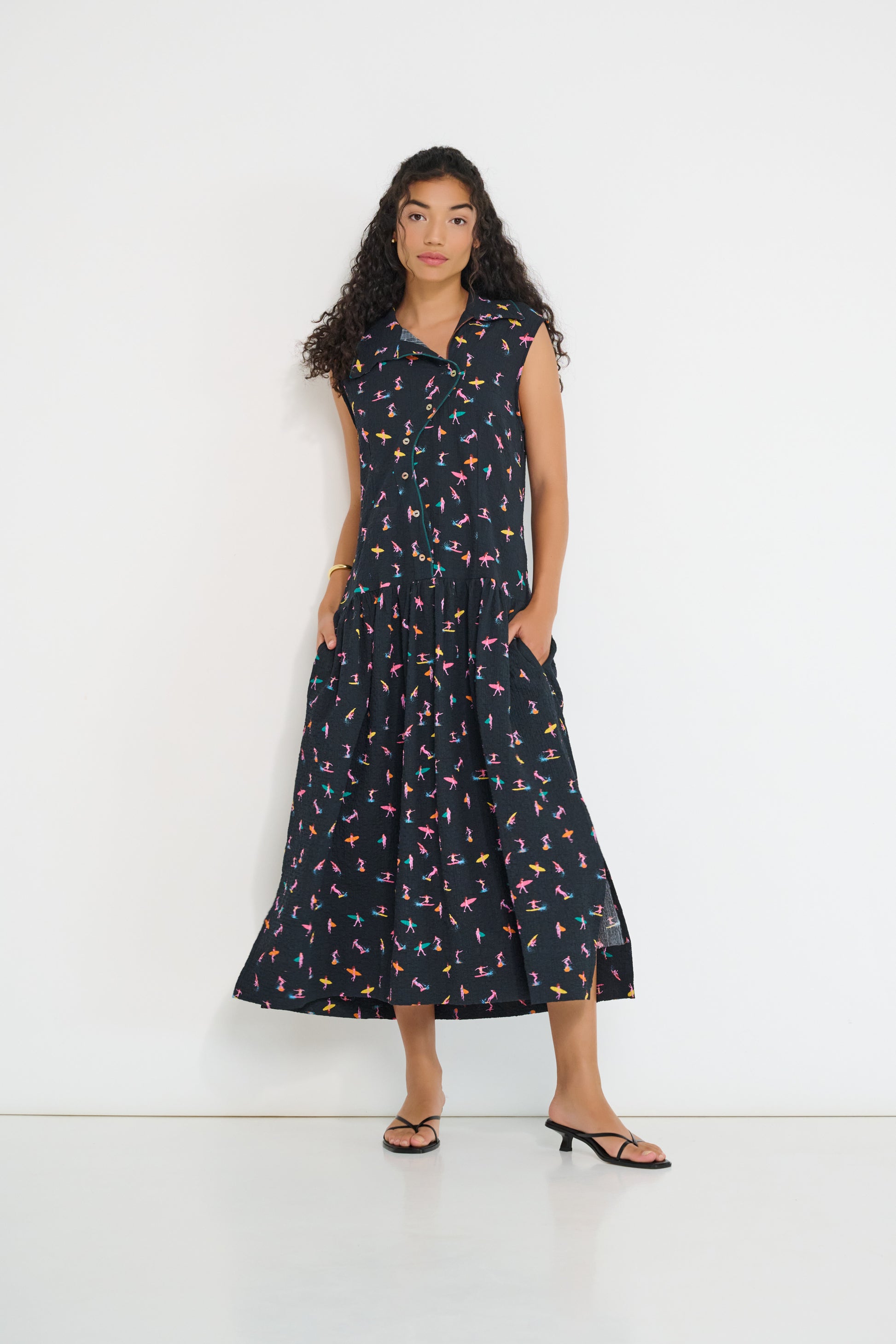 Reverie midi dress front view in black Petit Surfer French cotton seersucker with embroidered asymmetrical closure and drop waist silhouette made in Canada