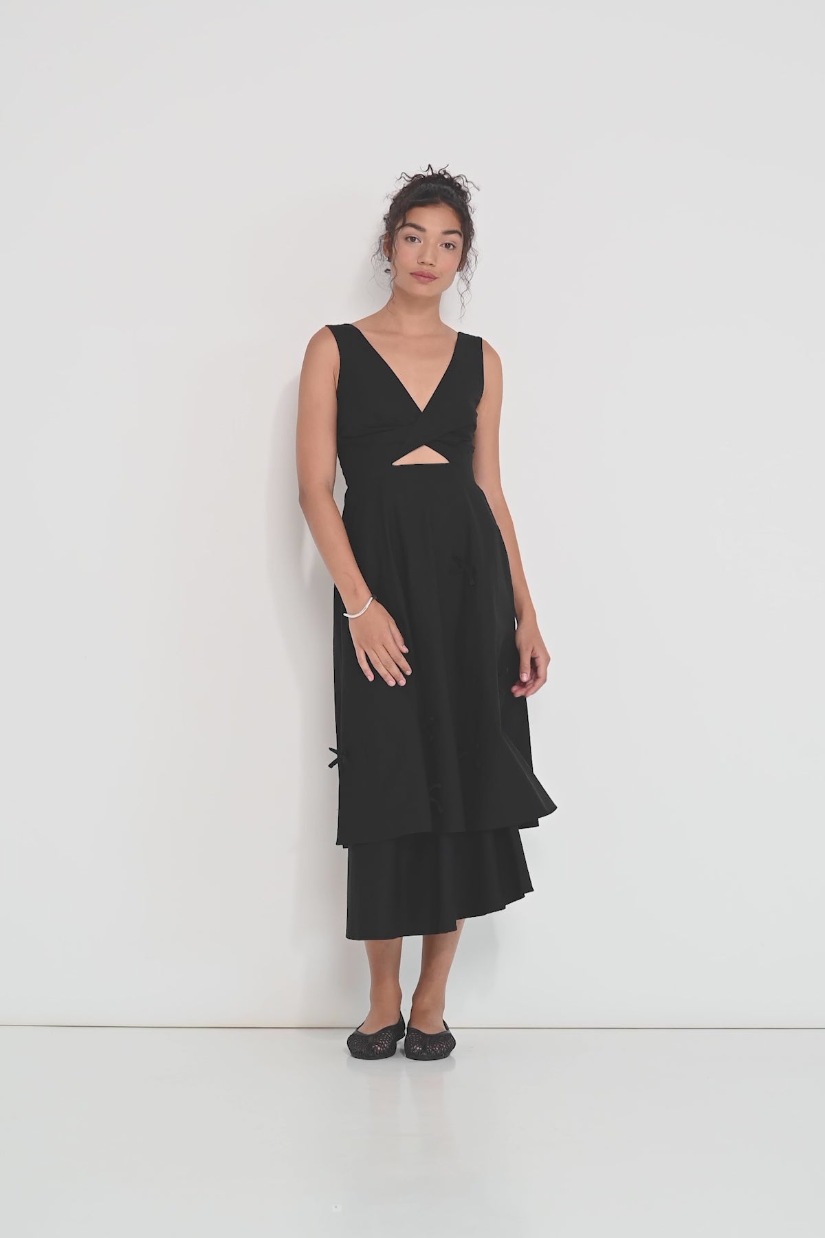 Twisted Basics dress in black Japanese twill on model showing movement of layered skirt and twisted bodice – Made in Canada