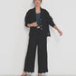 Voyage Pants black linen-viscose seersucker straight-leg pants with scalloped hem, elastic waistband and pockets, made in Canada.